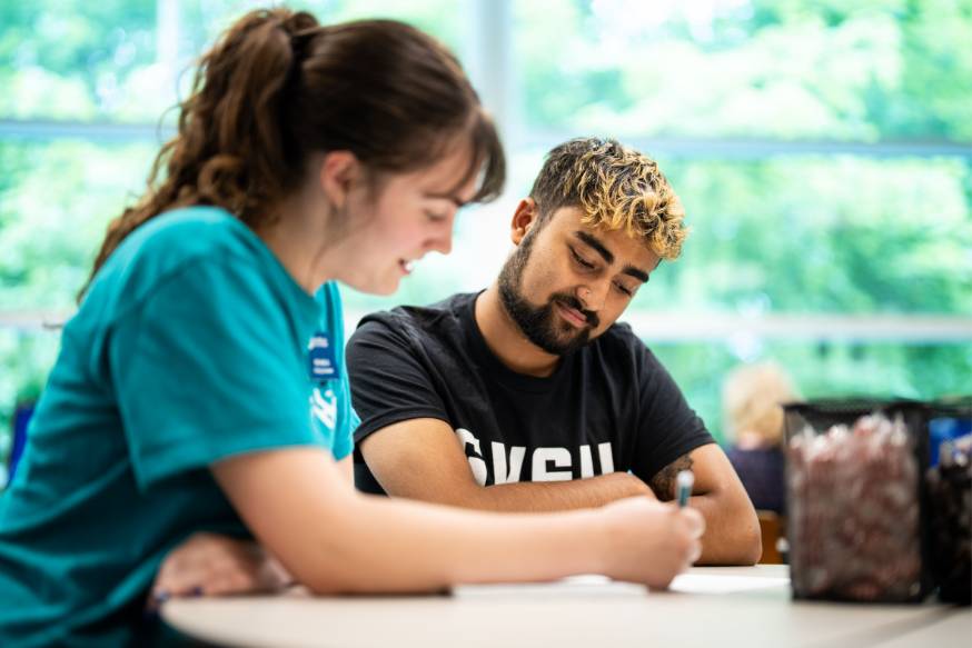 A student working with a writing consultant at the LOH 120 location